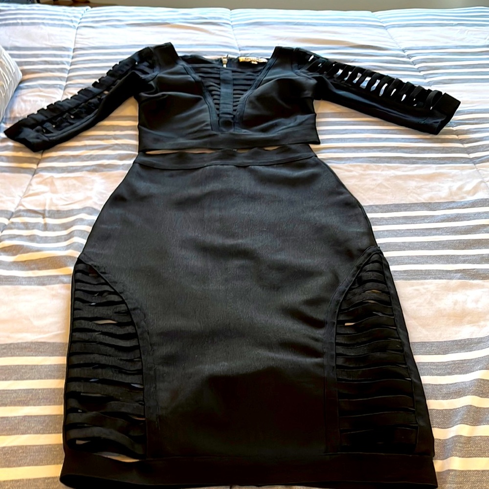 Black matching tops and skirt. Open striped front. Super sexy.